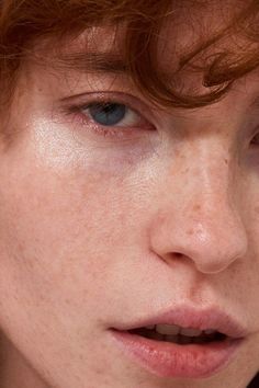 a woman with freckled hair and blue eyes