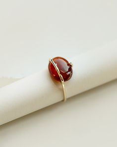 A limited edition garnet ring with a natural ethically sourced cinnamon red hessonite garnet set in yellow gold. The oval garnet cabochon is set in a unique band and prong setting to better showcase the beauty of the stone. Each ring is completely handmade in our studio using traditional goldsmithing techniques exclusively. Available in 9k & 18k solid yellow gold. Hessonite garnet: app. 14mm, app. 7cts, light blue, ethically sourced, origin: Central African Republic Band Width: 1.3mm, recycled g Garnet Ring For Men, Cabochon Ring Design, Oval Cabochon Ring, Modern Garnet Ring, Oval Stone Ring Design, Gernet Ring, Statement Garnet Ring, Oval Stone Rings, Hessonite Ring