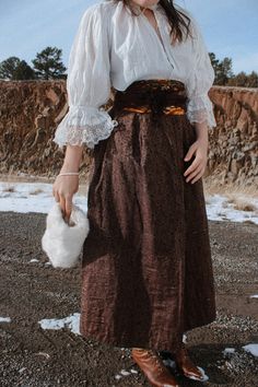 "A beautiful quilted brocade petticoat/skirt in a deep purply-brown. This item dates to about the 1870's-1880's based on the calico pattern and was most likely a winter skirt or petticoat. The waistband and lining are a richly patterned calico. There is a deep pocket at the right hip with remnant of the original price sticker on the interior of the skirt. The skirt fastens at the back with a large wooden button (not original). The shell of the skirt is most likely silk, and the lining is cotton. Condition: there are small tears and holes in the shell fabric scattered throughout, otherwise minor signs of wear due to age. This is a fragile garment and should be worn with care.  Measurements: Waist up to 25\" Hips up to 52\" 34\" waist to hem" Vintage Victorian Dress For Larp, Vintage Gathered Skirt For Costume, 1890s Skirt, Victorian Walking Skirt, Vintage Costume Gathered Skirt, Vintage Brown Tiered Skirt, Brown Full-length Lined Skirt, Vintage Cotton Brown Skirt, Petticoat Skirt