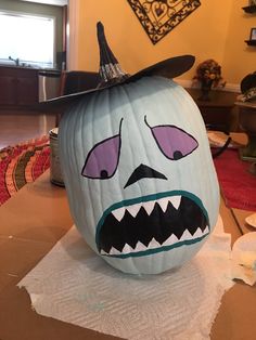 a pumpkin with a face painted to look like a monster