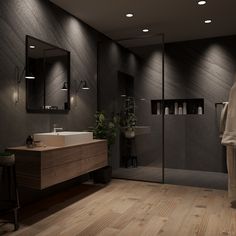 a bathroom with wooden floors and dark walls