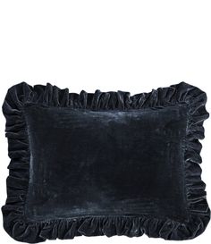 a black velvet pillow with ruffled edges