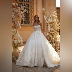 a woman in a wedding dress posing for the camera