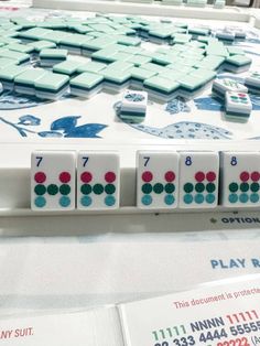 a close up of a board game with numbers and dices on the table in front of it