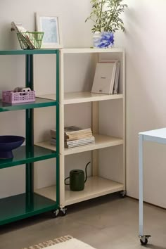 a shelf with books and other items on it next to a chair in a room