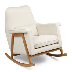 a white rocking chair sitting on top of a wooden frame