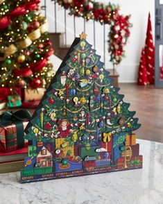 a wooden christmas tree with decorations on it