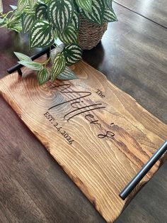 a wooden cutting board with the words happily married written on it and a pen next to it