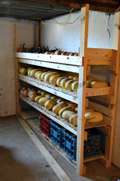 shelves filled with different types of doughnuts and pastries in an unfinished room