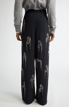 The Belgian design house blurs the lines between art and fashion with these wide-leg trousers detailed with sculpturally arrayed chains twinkling with crystals. 35" inseam; 22" leg opening; 13 1/2" front rise; 18 1/2" back rise (size 38 FR) Zip fly with hook-and-bar closure Side-seam pockets; back welt pockets 73% acetate, 27% viscose Dry clean Imported Designer Clothing Belgian Design, Chain Pants, Trousers Details, Womens Black Pants, Designer Clothing Brands, Art And Fashion, Dries Van Noten, Free Fabric, Black Fits