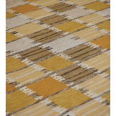 an area rug with yellow, brown and white checkered design on the carpet is shown