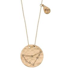 a gold necklace with the zodiac sign and stars on it, hanging from a chain