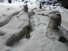 a fire hydrant is covered in snow next to a street light and other items