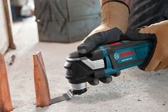 a person using a power tool on the floor