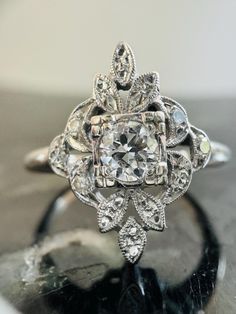 an old - fashioned diamond ring sits on top of a table