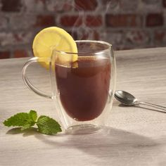 a cup of hot chocolate tea with lemon and mint