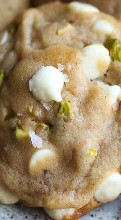 two cookies with white and green toppings sitting on a doily