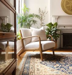 a living room filled with furniture and a clock on the wall above a fire place