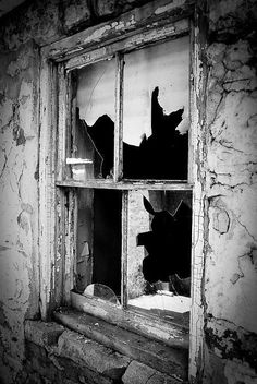 an old window with broken glass in it