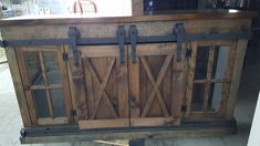 an old wooden cabinet with sliding doors on it