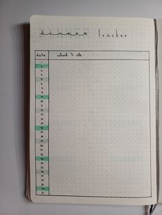 an open notebook with numbers and lines on the page, which is lined in green