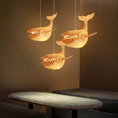 three fish shaped lights hanging from the ceiling