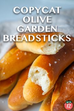 some bread sticks are stacked on top of each other with the words copycat olive garden breadsticks