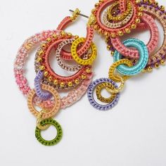 multicolored beaded hoop earrings on white background