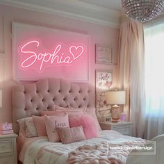 a bedroom with pink walls and lights above the bed, along with a chandelier