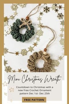 two christmas wreaths hanging from strings on top of a white table with gold stars