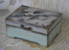 an old fashioned box sitting on top of a table