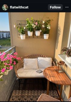 a balcony with potted plants and flowers on it