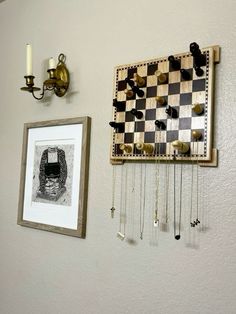 a chess board hanging on the wall next to a framed photograph