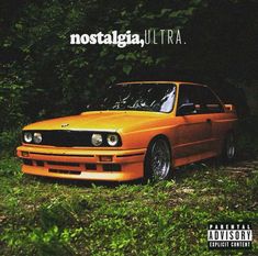 an orange car is parked in the grass near some trees and bushes, with the words nostalgicia ultra above it