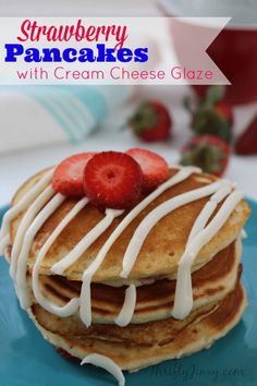 strawberry pancakes with cream cheese glaze on a blue plate