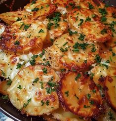 a pan filled with potatoes covered in cheese and parsley