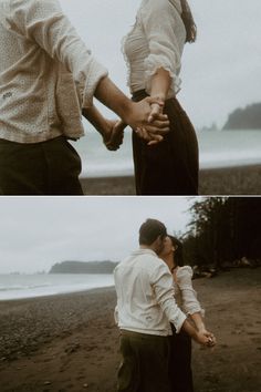 two people are holding hands on the beach