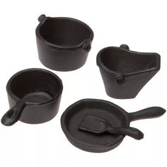 four pieces of black cast iron cooking utensils