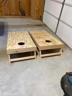 two pieces of wood sitting next to each other on the floor in front of a garage door