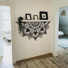 a wall shelf with pictures on it in a living room next to a door way