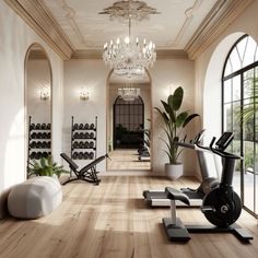 a gym with exercise equipment and large windows