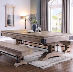 a dining room table with benches in front of it and a vase on the table