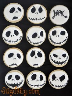 decorated sugar cookies with jack skellings and faces on them for the halloween party