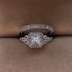 an engagement ring set with a princess cut diamond in the center