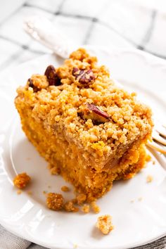 a piece of cake sitting on top of a white plate with a fork next to it