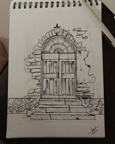 a drawing of an open door on a piece of paper with a pen next to it