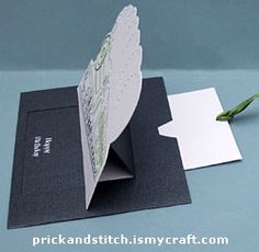 a folded card with a single flower on it