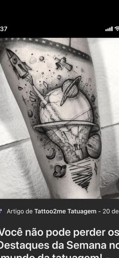 a person with a tattoo on their leg that has an image of the moon and saturn