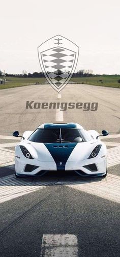 a white and blue sports car on a race track with the words koenisego above it