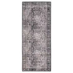 a gray and black rug with an ornate design on the bottom, in front of a white background